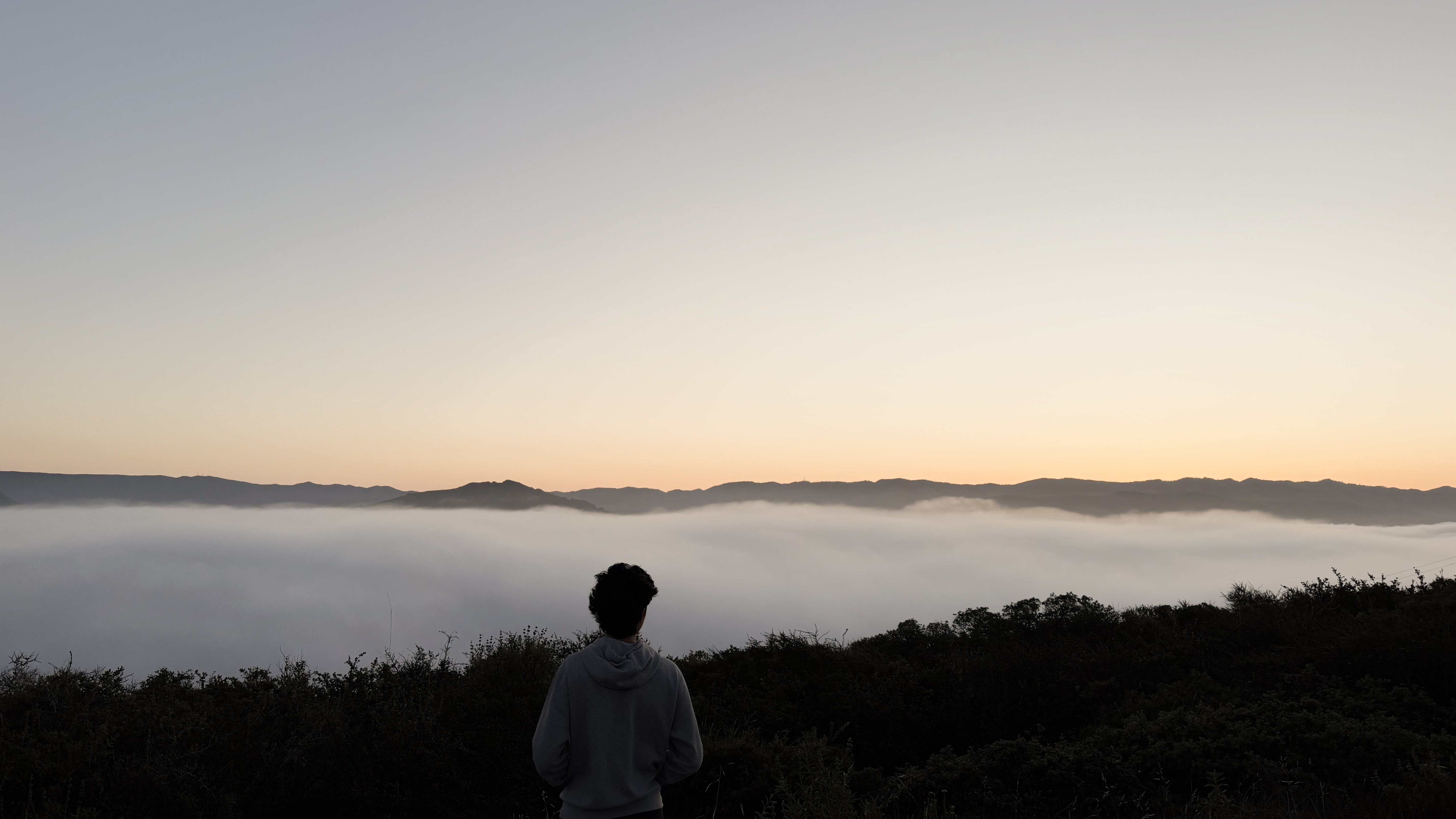 Isaac Tsai overlooking a mountain landscape